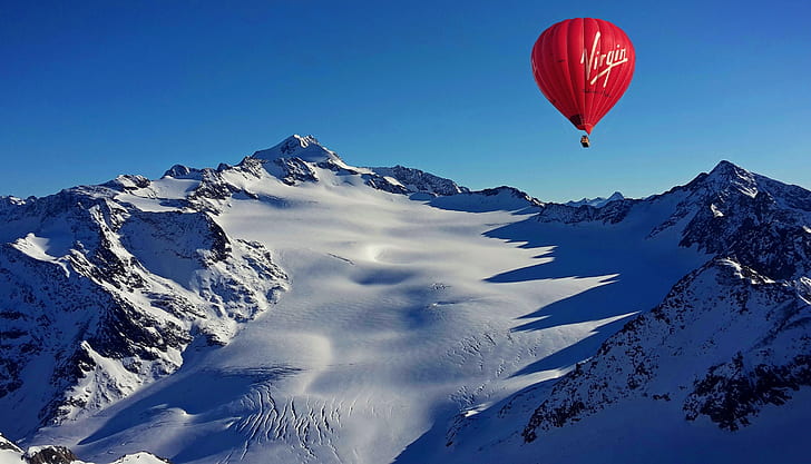 red Virgin air balloon near mountain