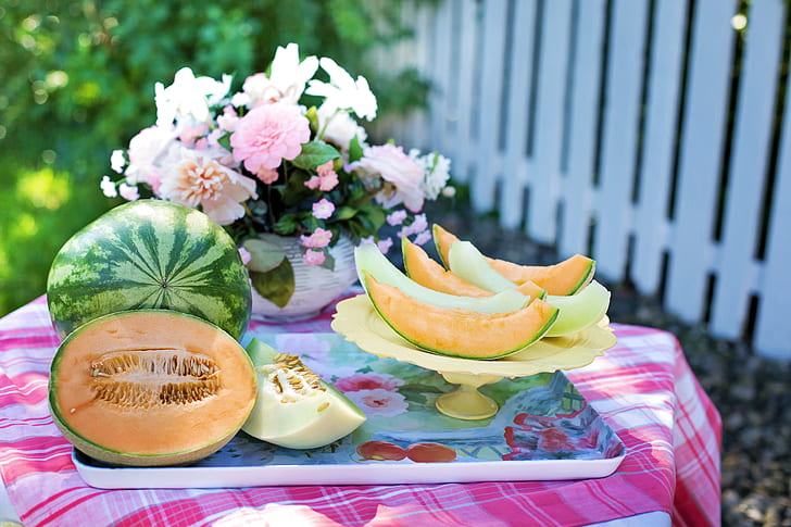 sliced melon and watermelon fruits on beige tray