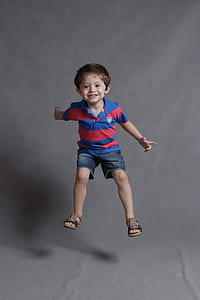 boy in blue and red polo shirt and blue denim boat shorts