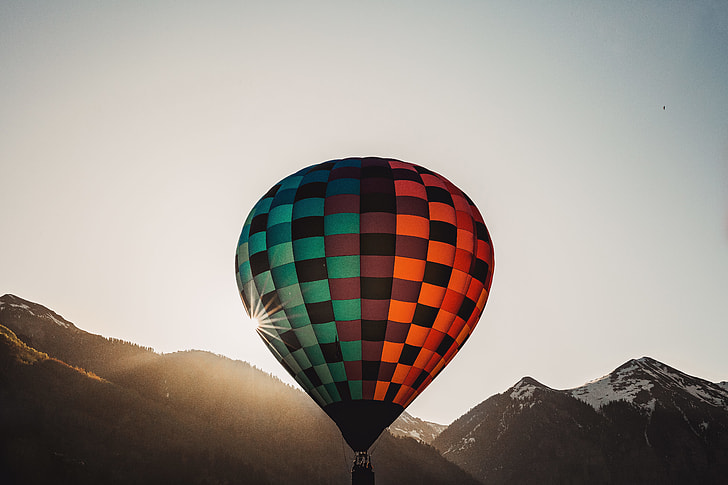 red, brown, and teal hot air balloon