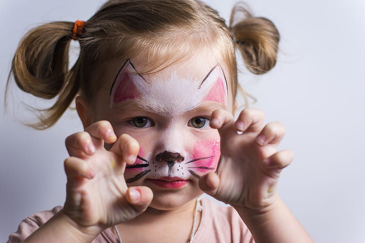 girl with face paint showing cat claws