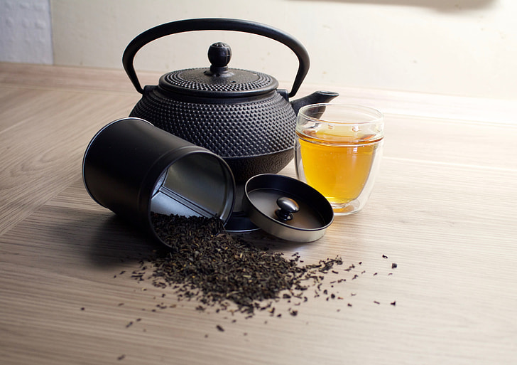teapot near can of tea photography