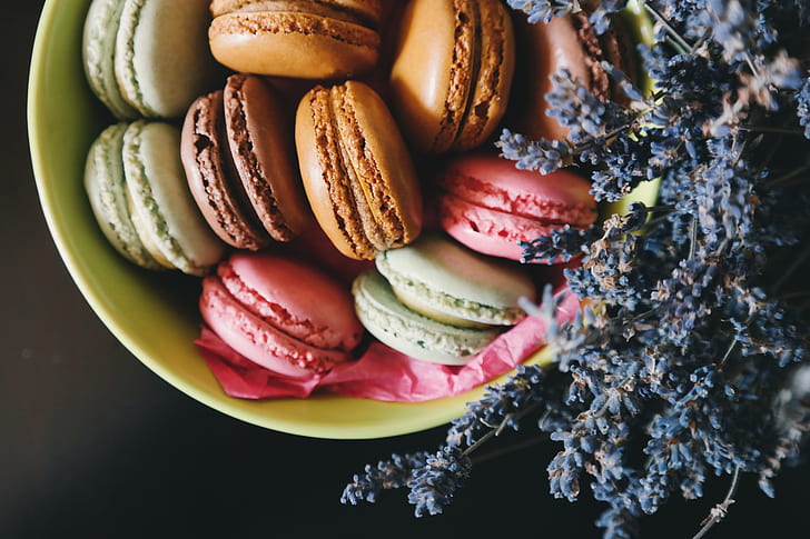 assorted-color macaroons on green bowl
