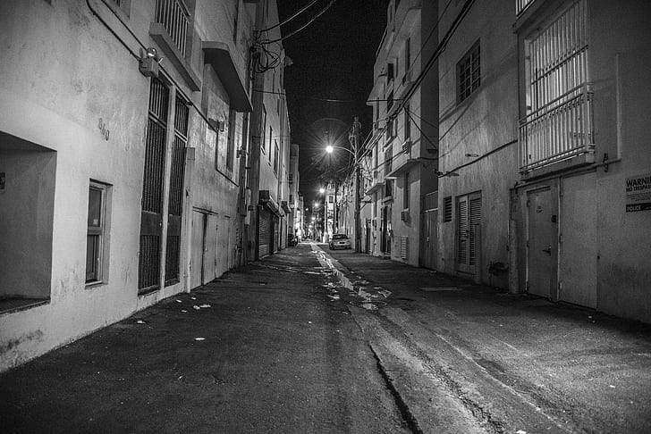grayscale photography of street between buildings