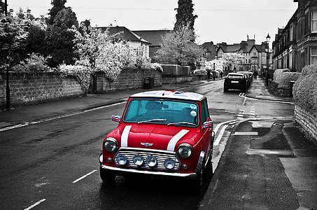 selective photography of red Mini Cooper parked building