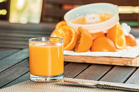 orange juice and fruits on brown wooden table