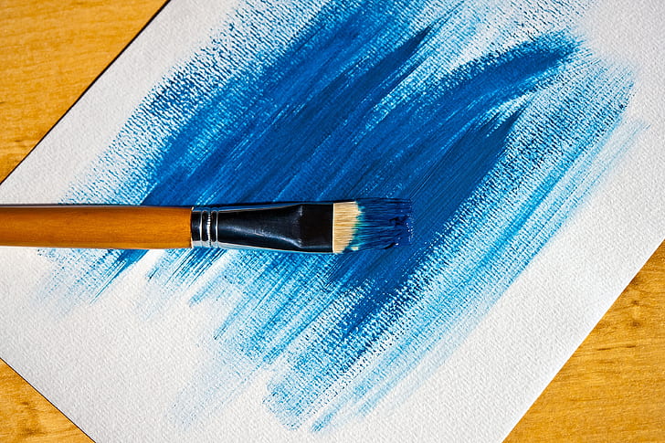 brown paint brush on white board