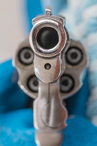 gray revolver pistol in selective focus photography