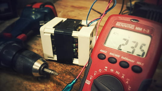 close-up photo of red Benning MM 1-3 multimeter at 235