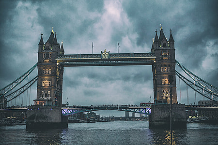 Wide angle shot of Tower Bridge in London at dusk on a grey day