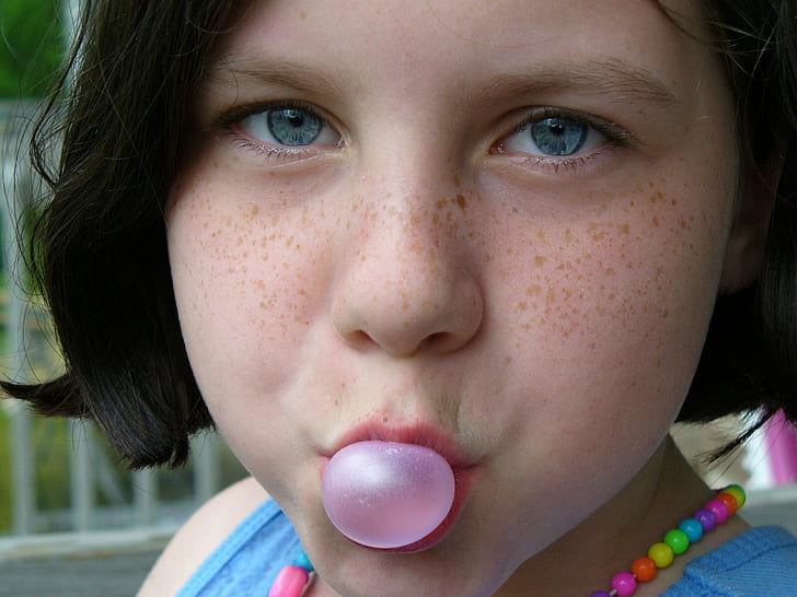 girl playing with bubblegum