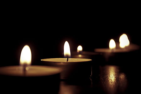 depth of field photography of lighted candle