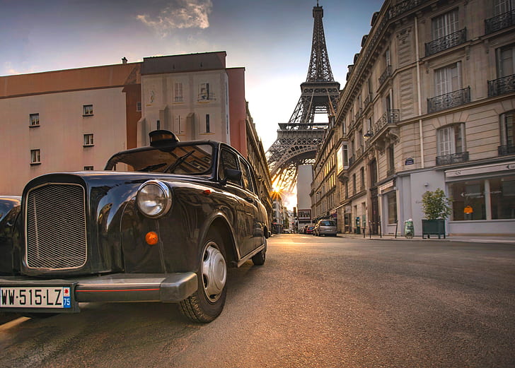 photo of black car on pavement with Eiffel Tower background