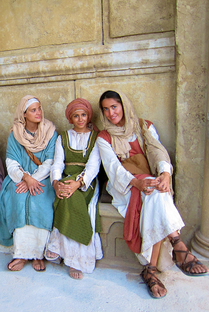three woman wearing traditional dresses