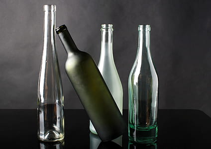 four clear glass bottles