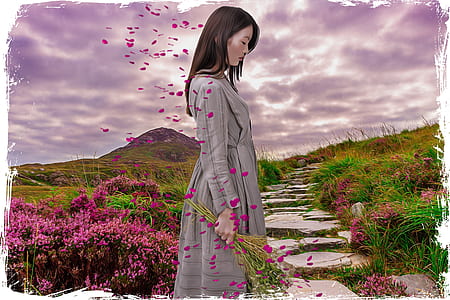 woman in gray long-sleeved dress near pink flowers