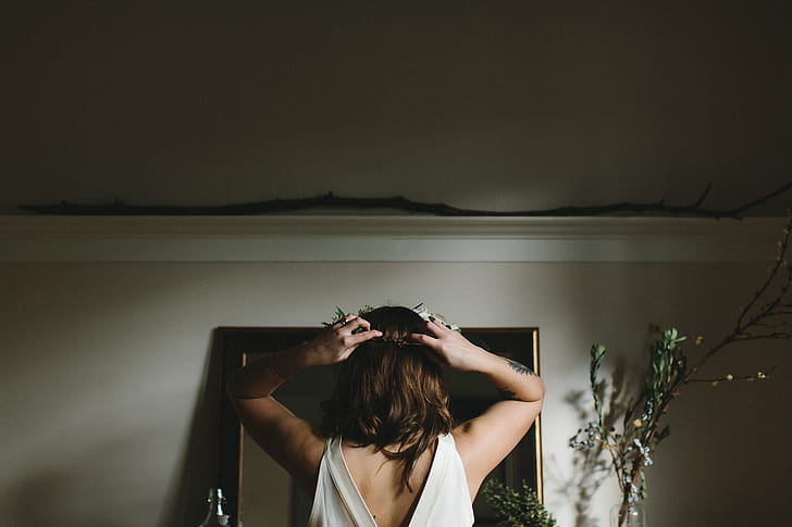 woman standing in front of mirror