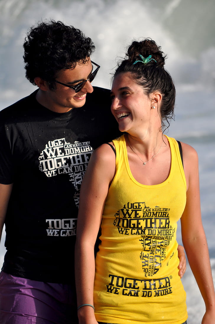 woman wearing yellow printed tank top and man wearing black printed t-shirt