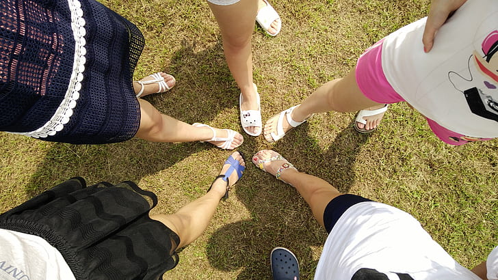 five women wearing sandals