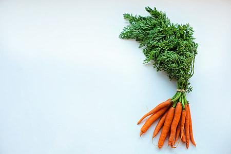 bunch of carrots on white surface