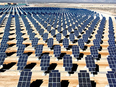 solar panel lot on brown field during daytime