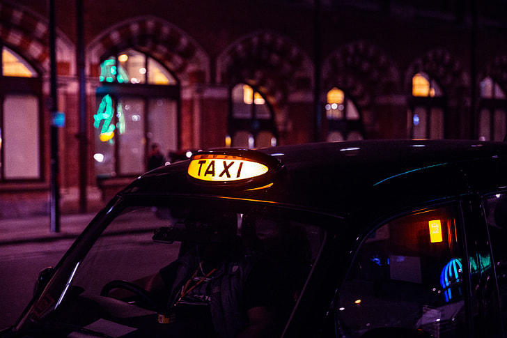 A black London taxi waits for business