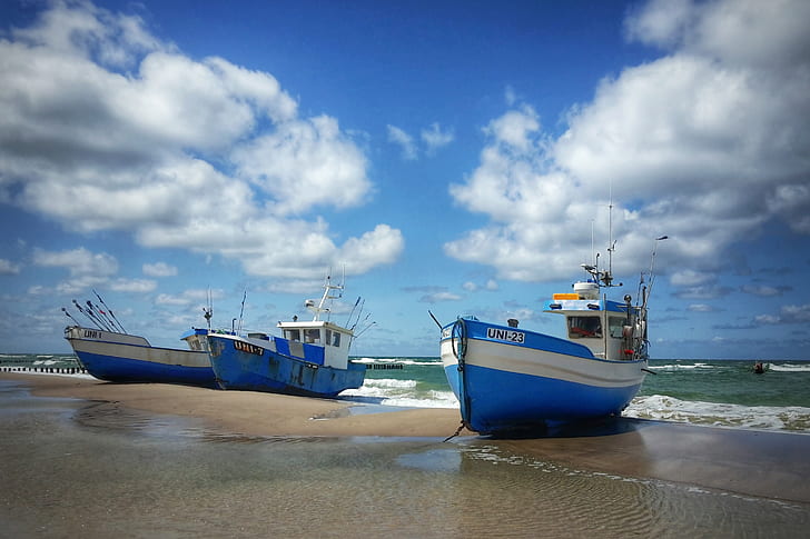 two blue ships on seashore