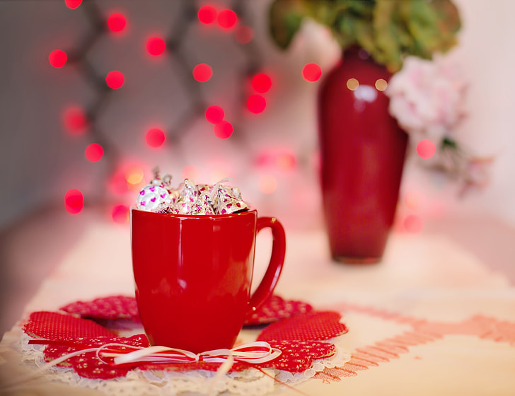 chocolate candies in red ceramic mug