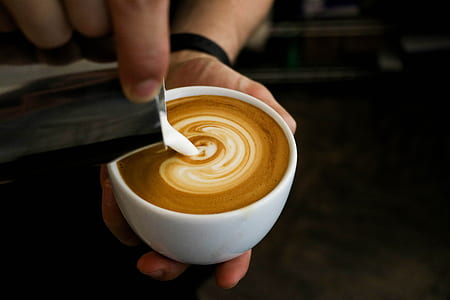 white ceramic teacup with latte