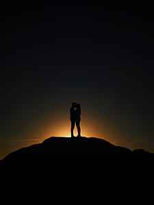 silhouette of two person kissing