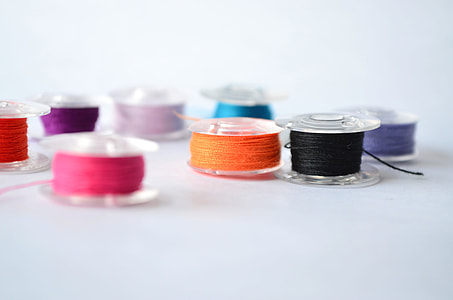 shallow focus photography of assorted-color threads