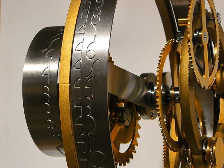 grey and brass-colored mechanical gears close-up photo