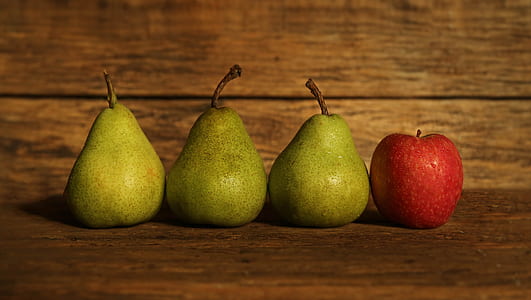 three green pears and red apple
