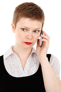 woman with white and black collared shirt using white QWERTY phone