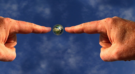 person pointing on earth digital wallpaper