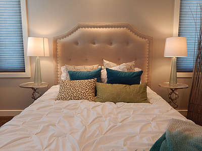 white bed sheet and tufted headboard