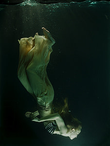 woman diving through the water