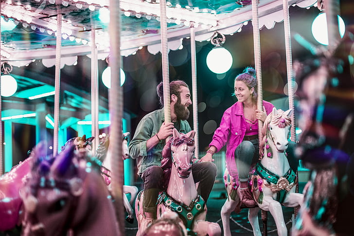 couple riding on horse carousel