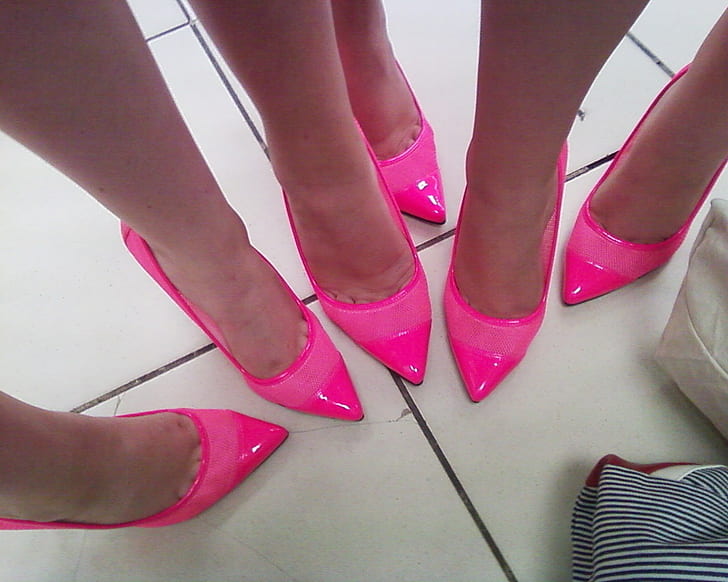 three women wearing pink patent leather pointed-toe heeled shoes