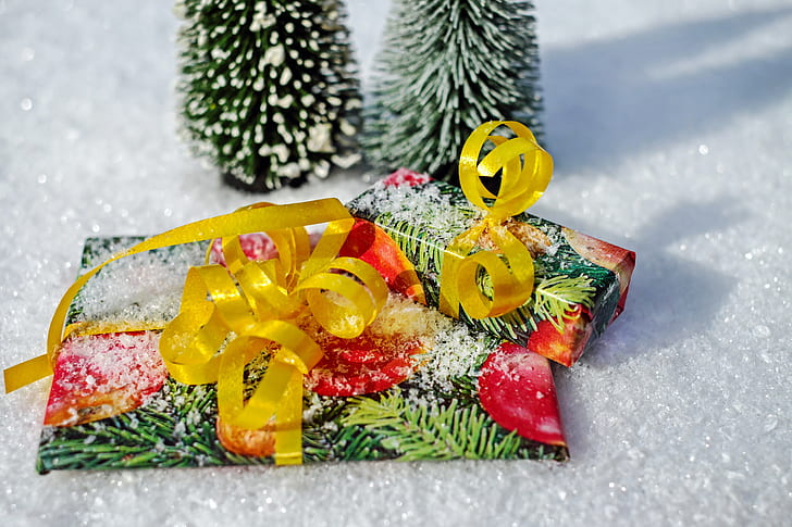 multicolored gift wrap beside Christmas tree
