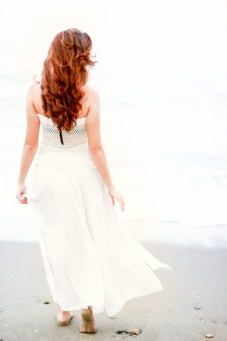 woman in white dress by the seashore photo