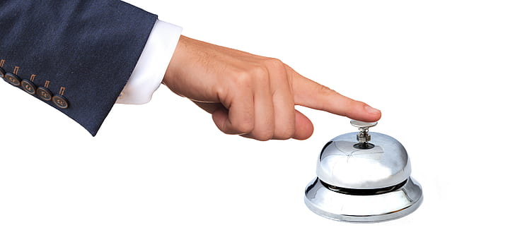 person holding ring bell