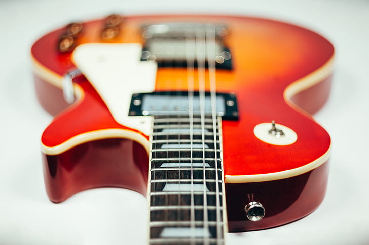 shallow focus photography of red electric guitar