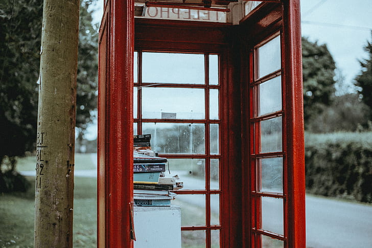 shallow focus photo of red telephone booth