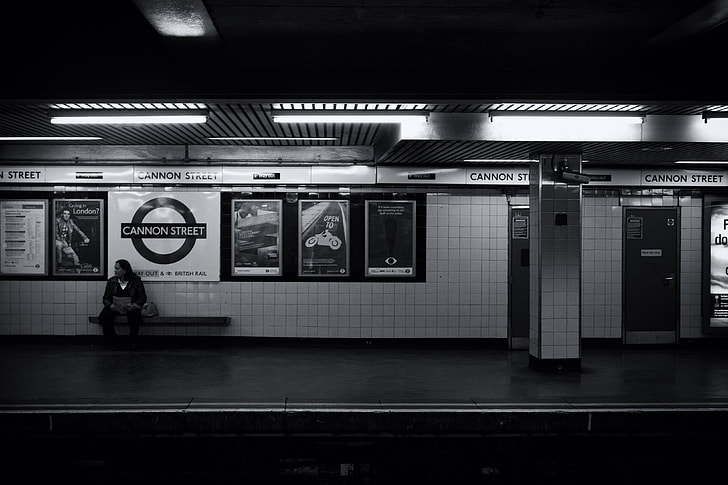 A man waits alone on the tube platform on the London Underground
