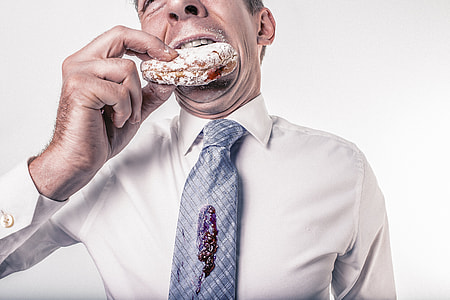 man having bite of donut