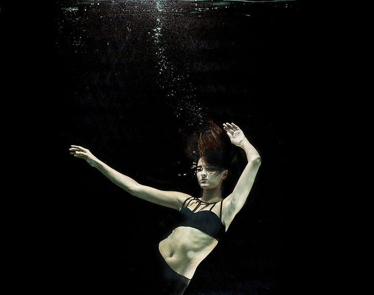 woman wearing black bikini top under water photography