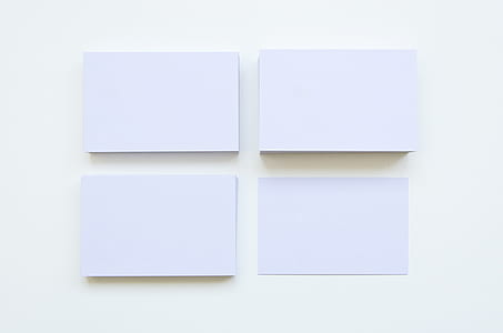 four rectangular white printer papers