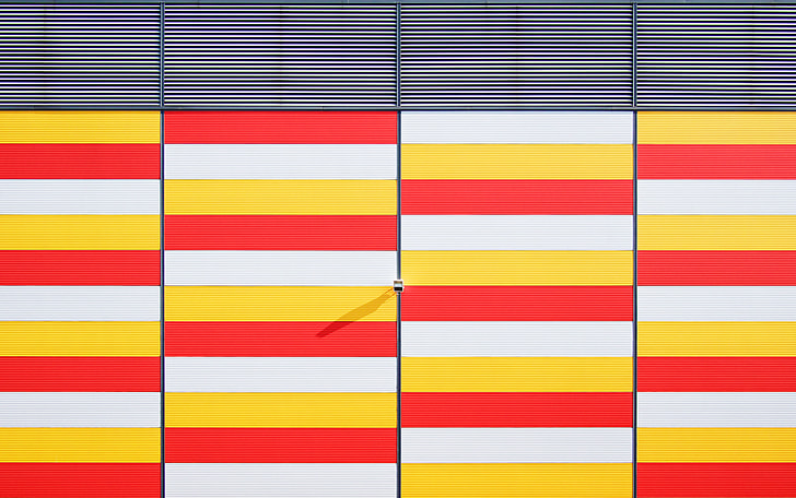 architectural photography of white, red, and yellow gate