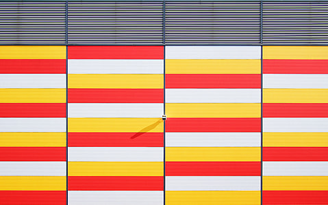 architectural photography of white, red, and yellow gate